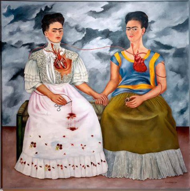 Frida Kahlo with a significant monobrow and a luminous gold mustache